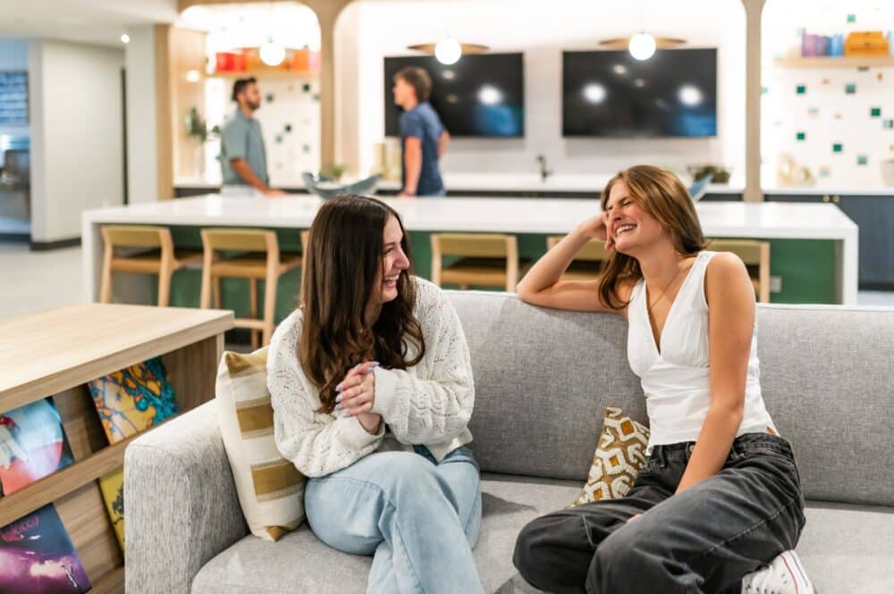 Aperture residents hanging out in the community clubroom and lounge
